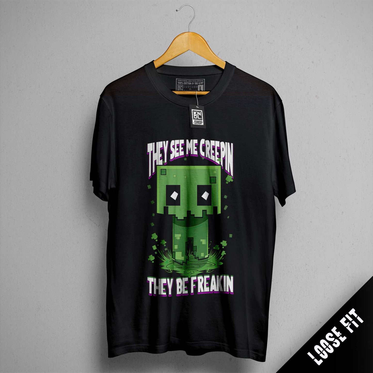 a black t - shirt with the words they see me certain they're freak