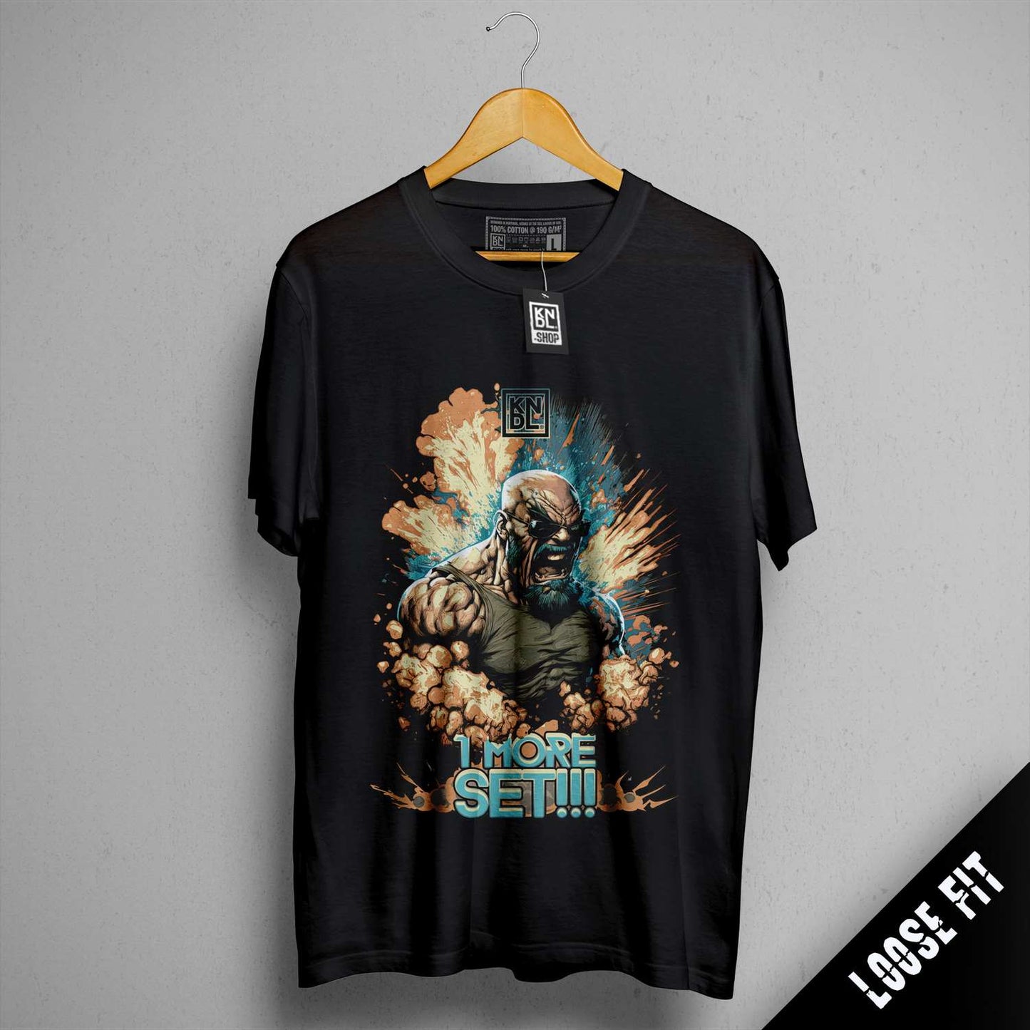 a black t - shirt with a picture of a man holding a gun