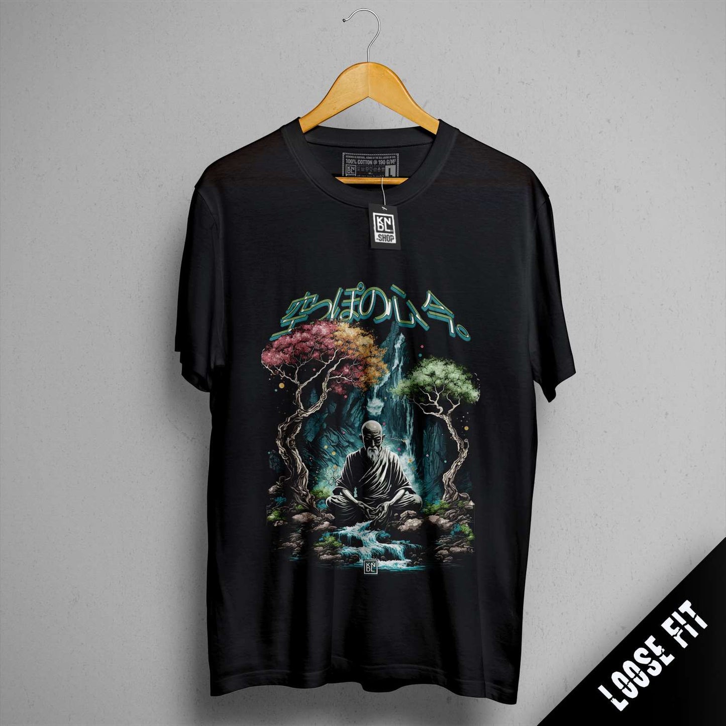 a black t - shirt with a picture of a man sitting on a rock in