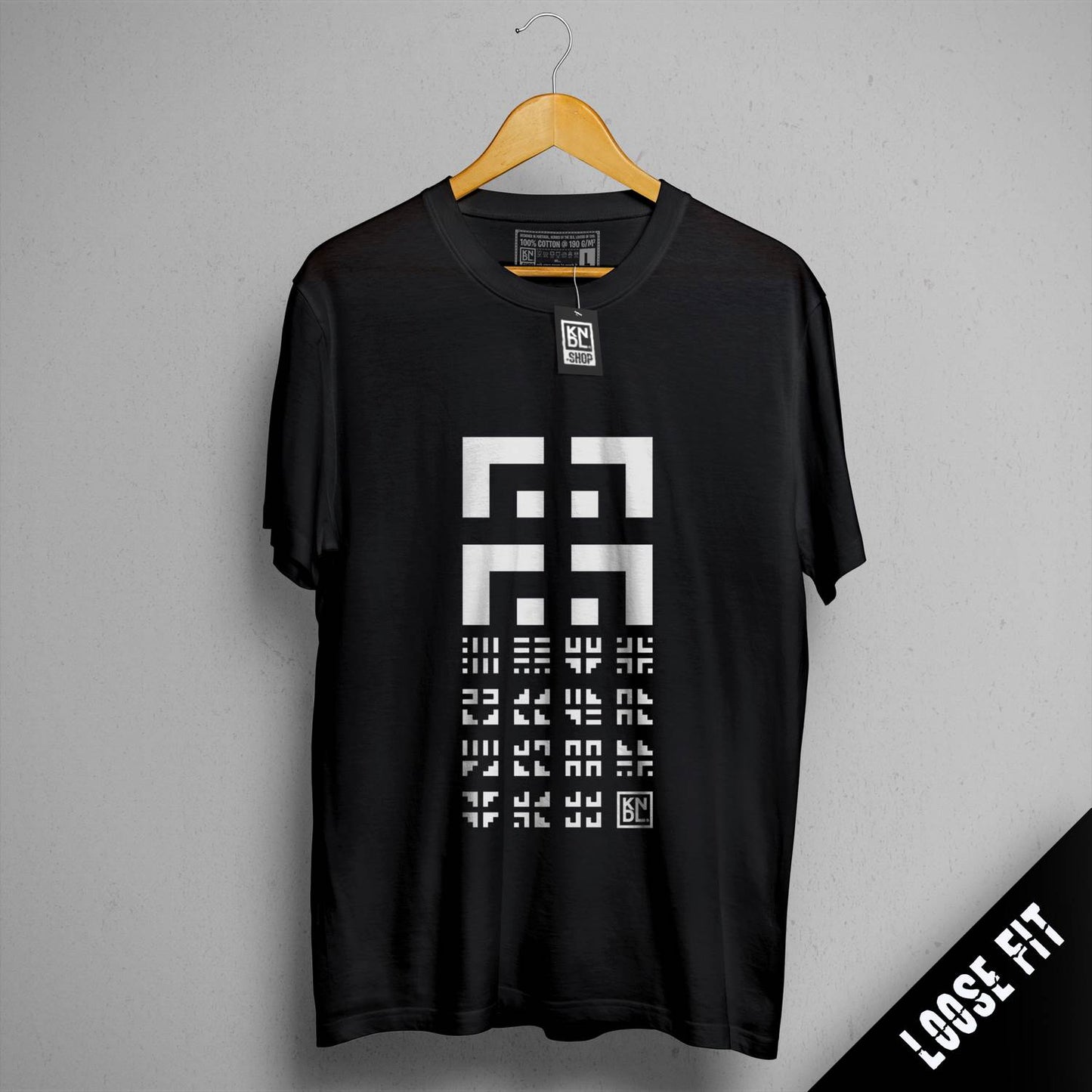 a t - shirt hanging on a hanger on a wall
