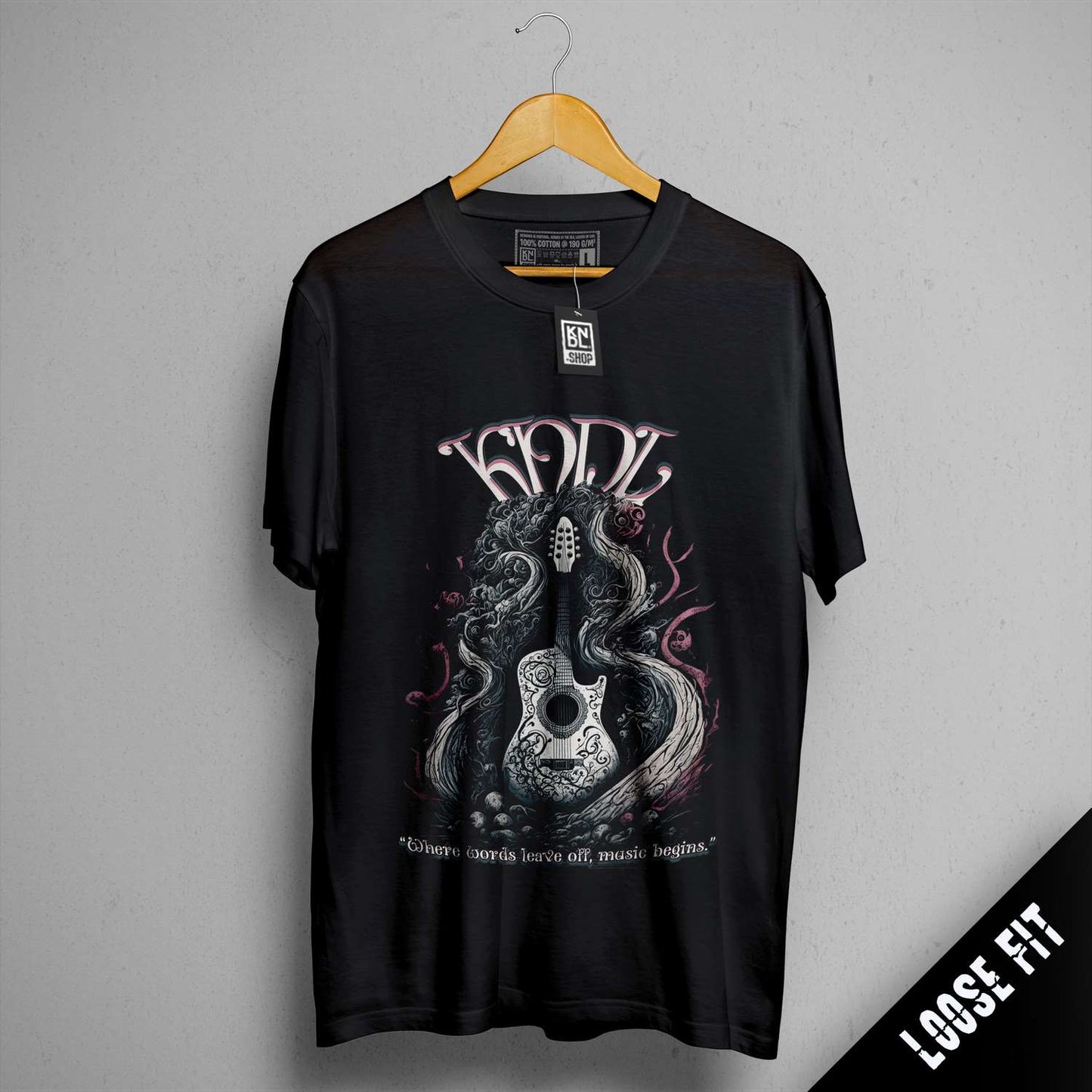 a black t - shirt hanging on a wall