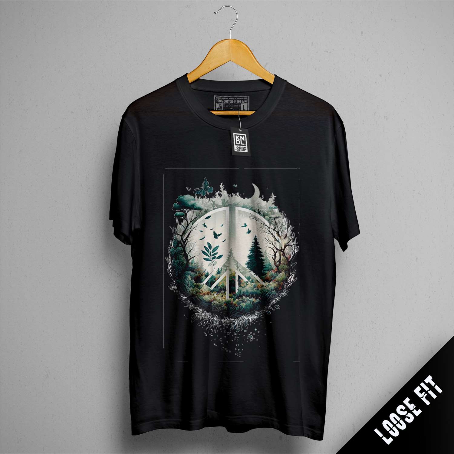 a black t - shirt with a picture of a forest