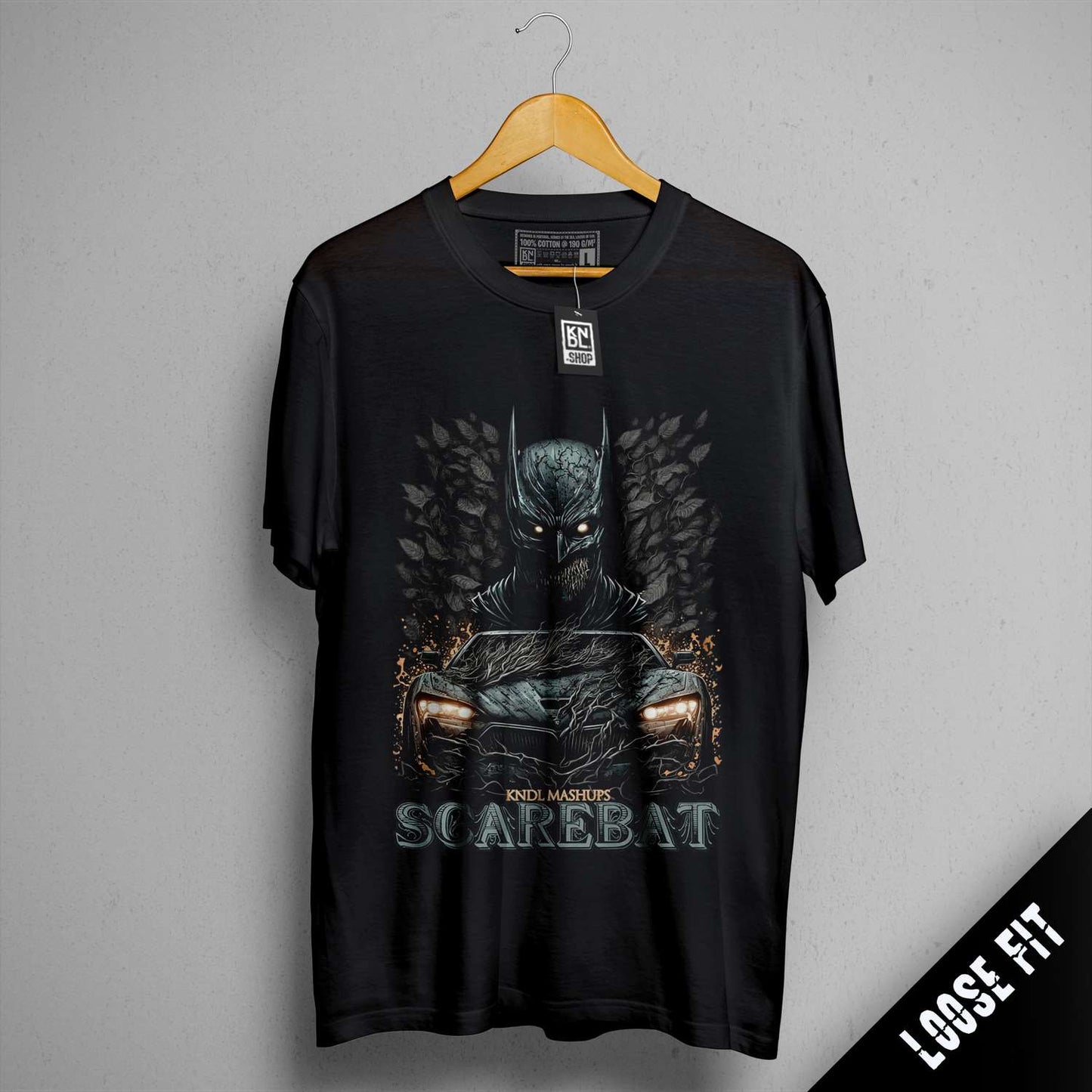 a batman t - shirt hanging on a wall
