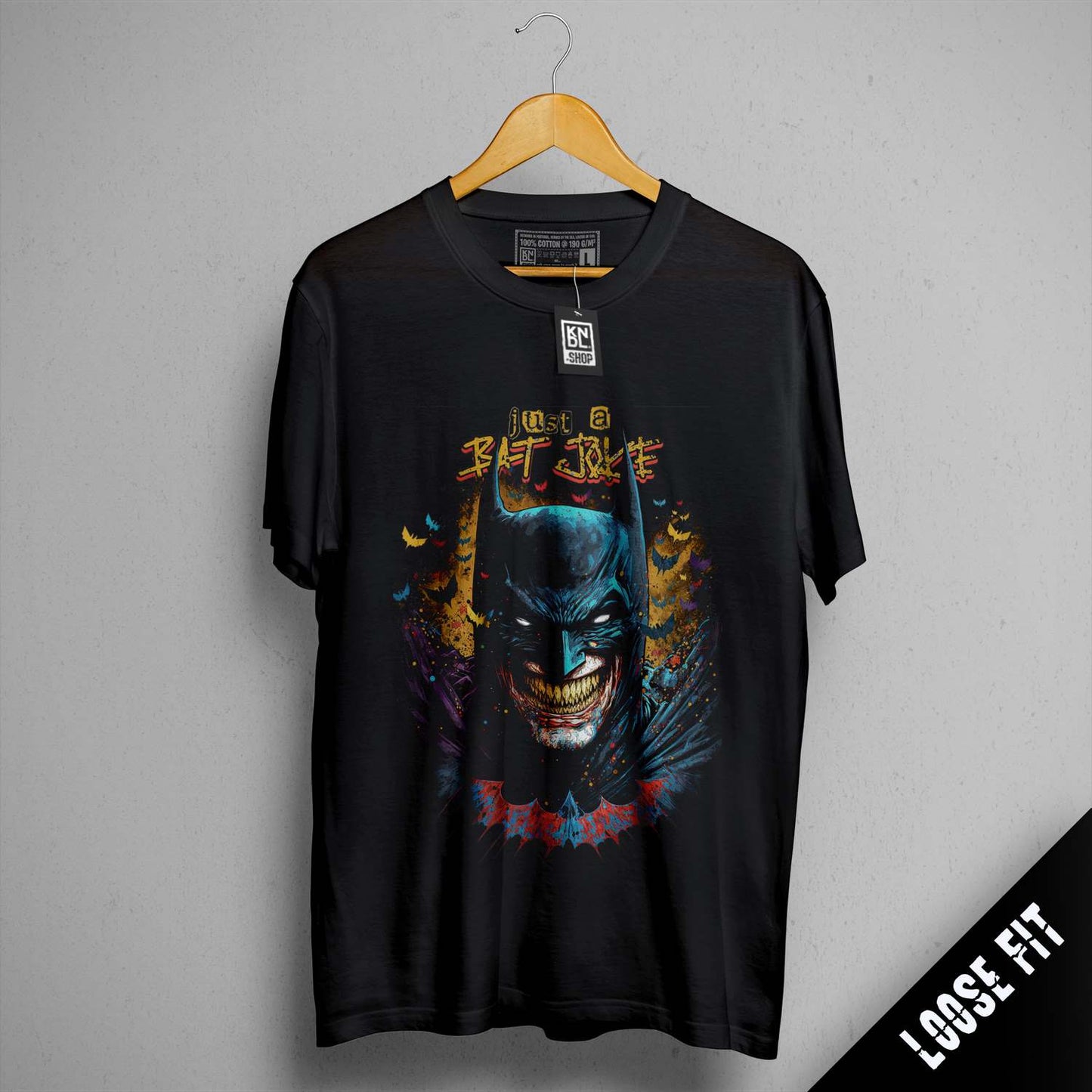 a batman t - shirt hanging on a wall