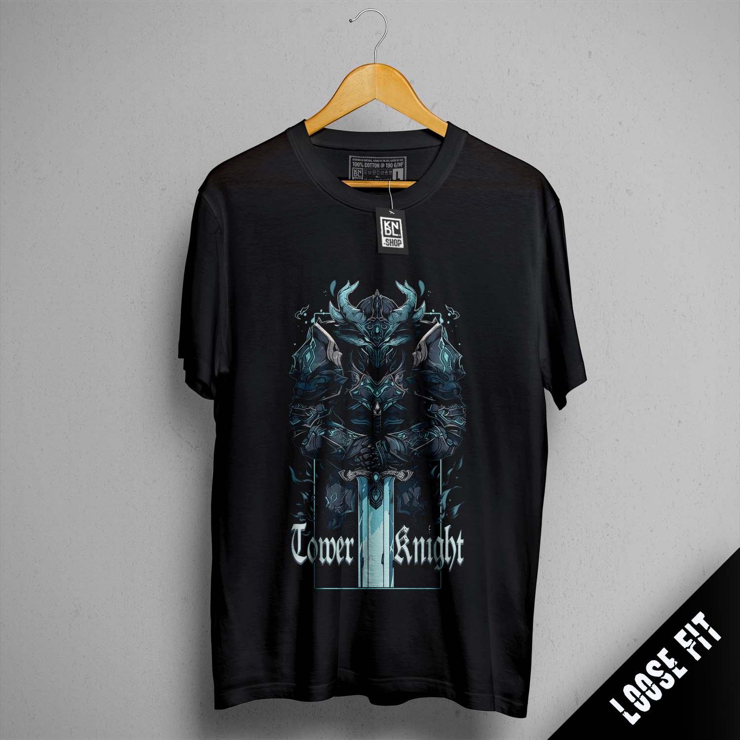 a black t - shirt hanging on a hanger