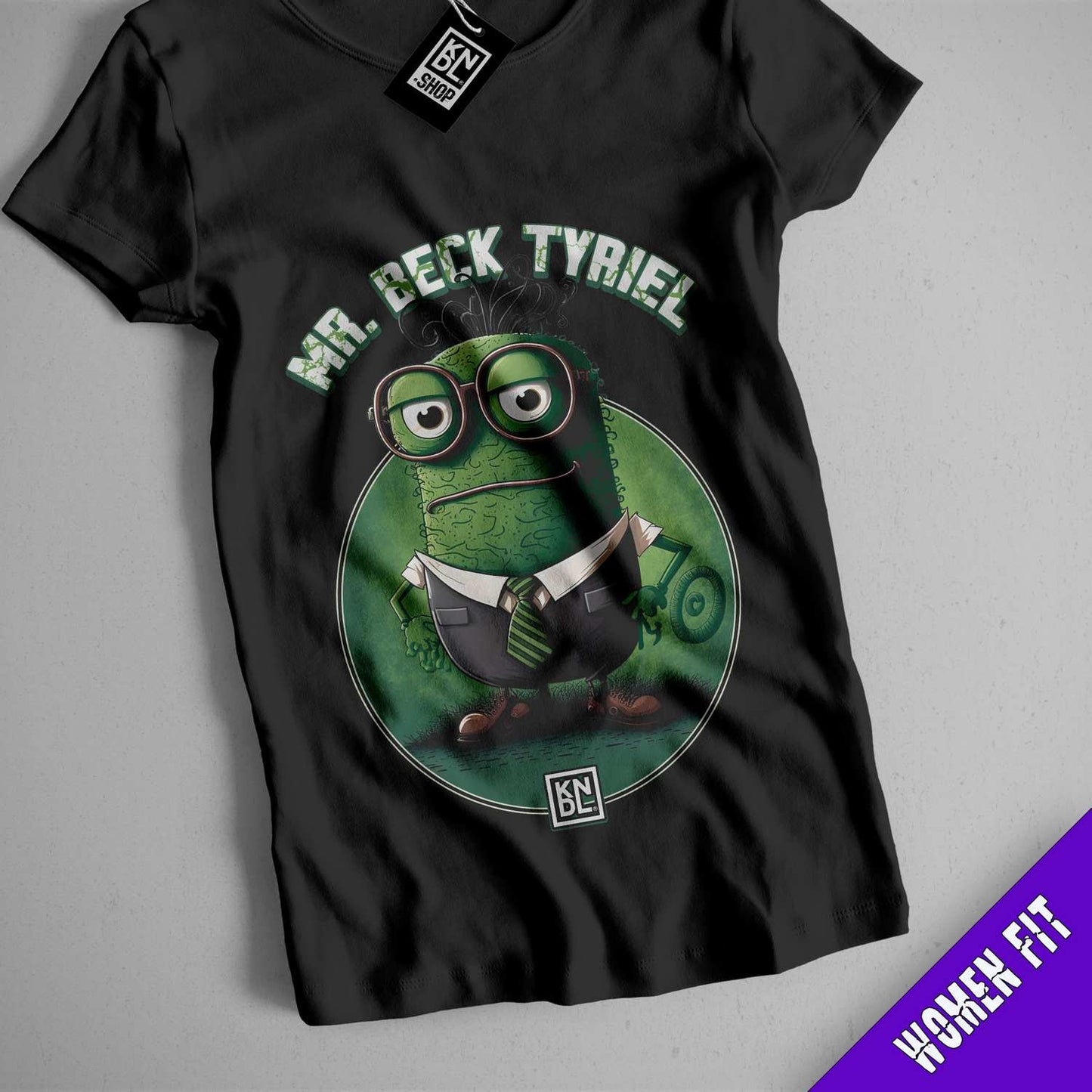 a black t - shirt with an image of a green monster reading a book