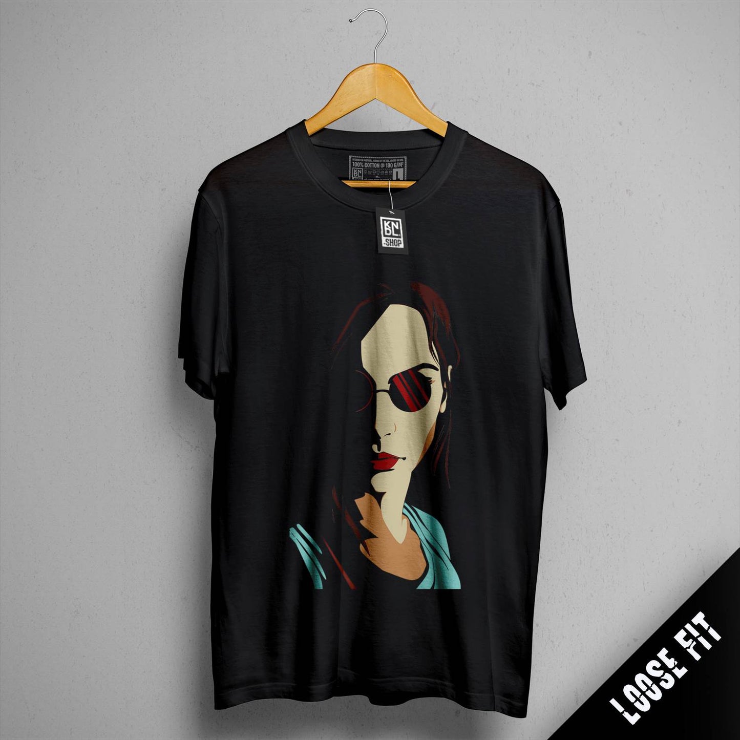 a black t - shirt with a picture of a woman wearing sunglasses