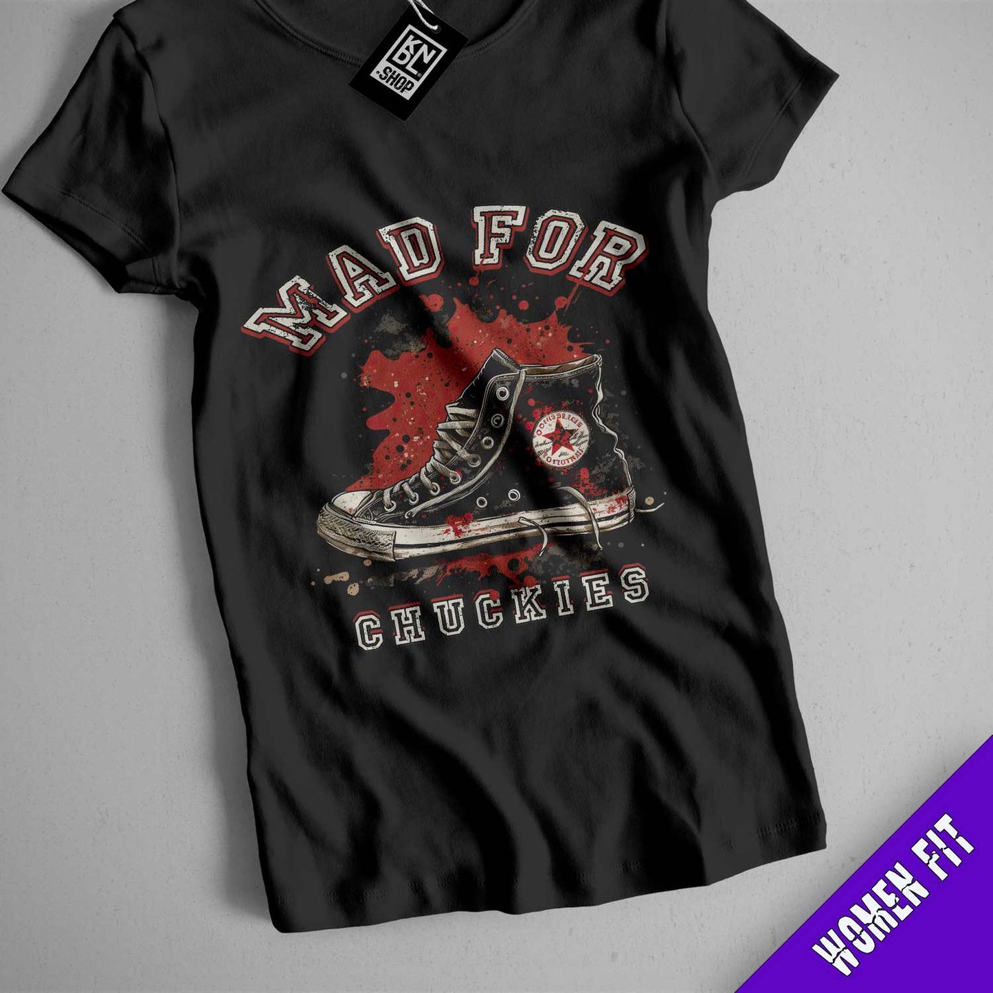 a black shirt with a pair of shoes on it