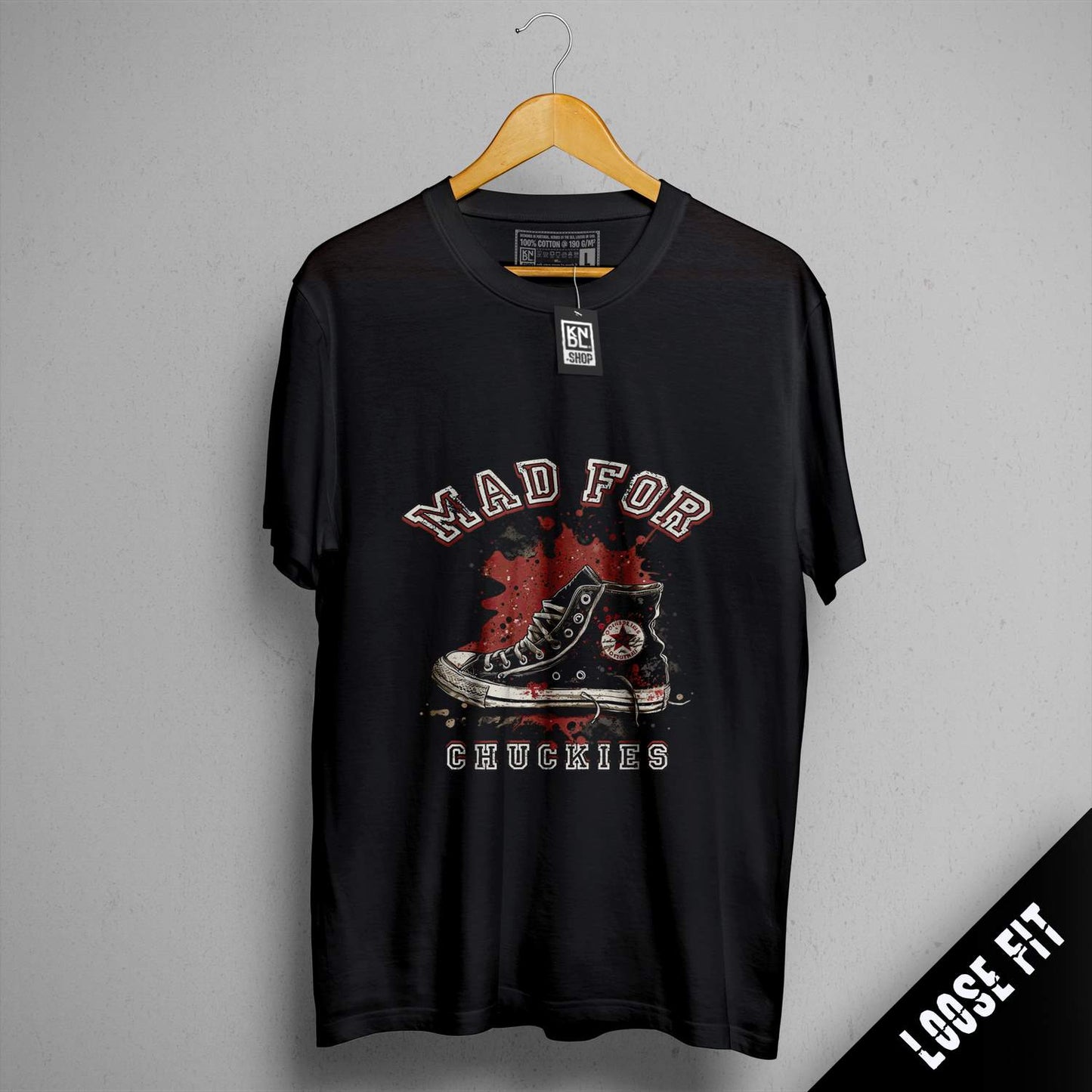 a black shirt with a picture of a pair of shoes on it