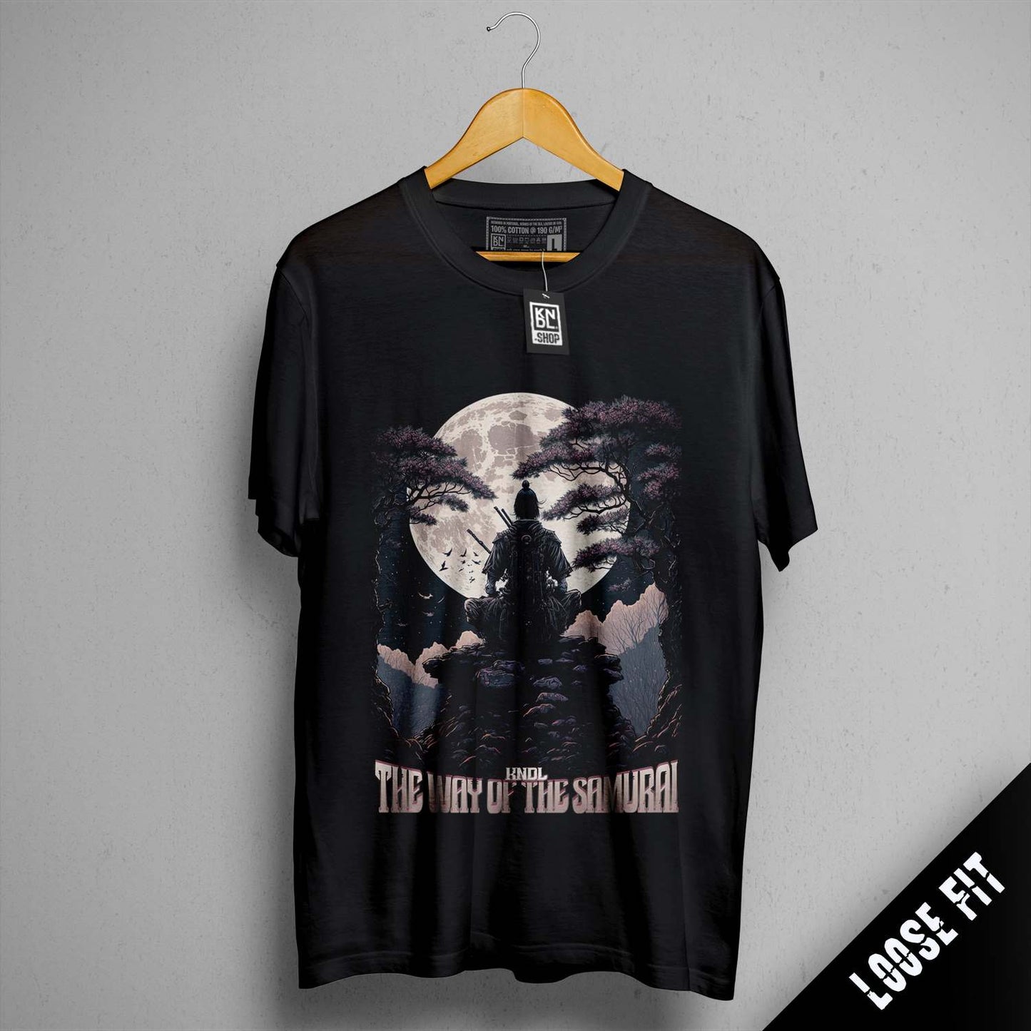 a black t - shirt with a picture of a man standing on a hill