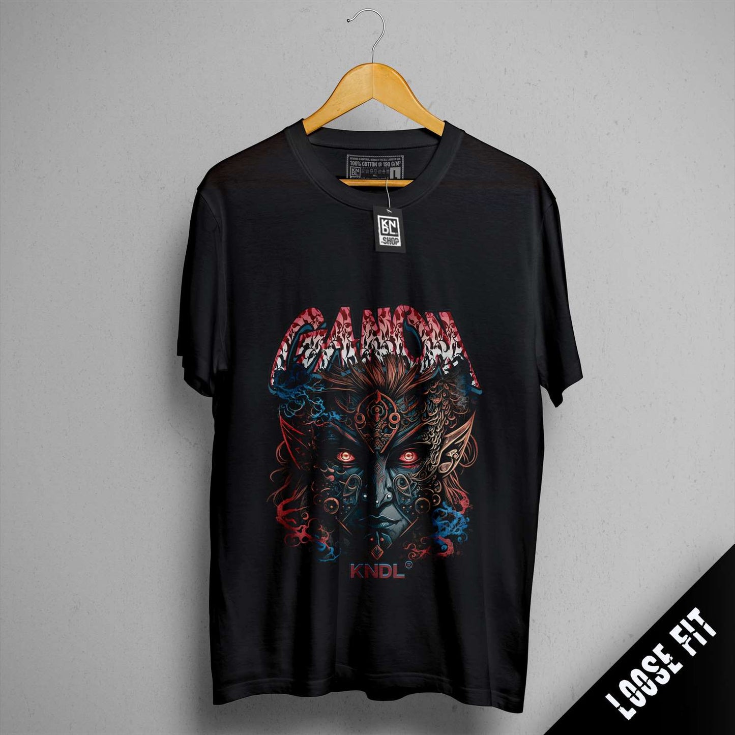 a black shirt with a picture of a demon on it