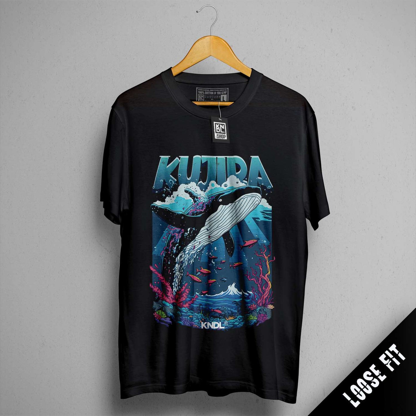 a black t - shirt with a picture of a whale jumping out of the water