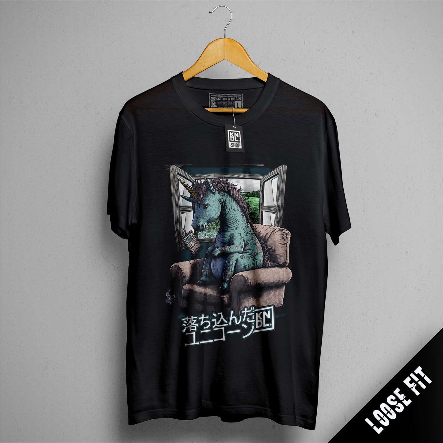 a t - shirt with a picture of a dragon sitting on a couch